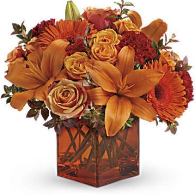 <div id="mark-3" class="m-pdp-tabs-marketing-description">Celebrate the wonder of a new day with warm, golden flowers. A modern orange glass vase is the foundation of this stunning, sun-bright bouquet that energizes any occasion.</div>
<del> </del>

 
<ul>
 	<li>Orange gerbera daisies, orange roses and red mini carnations are accented with a spray of red huckleberry in an orange cube</li>
</ul>
<div id="desc-3">
<ul>
 	<li>vase.</li>
</ul>
</div>
 
<ul>
 	<li></li>
</ul>
 