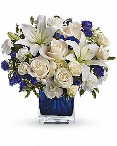 <div class="m-pdp-tabs-description">
<div id="mark-1" class="m-pdp-tabs-marketing-description">Send someone a bit of heaven with this beautiful bouquet. Luxurious crème roses and pure white lilies paint a peaceful picture inside a blue cube.</div>
</div>
<p id="arrngDescp">Crème roses, white asiatic lilies and white miniature carnations are mixed with bursts of purple statice and green pitta negra. Delivered in a glass cube.</p>