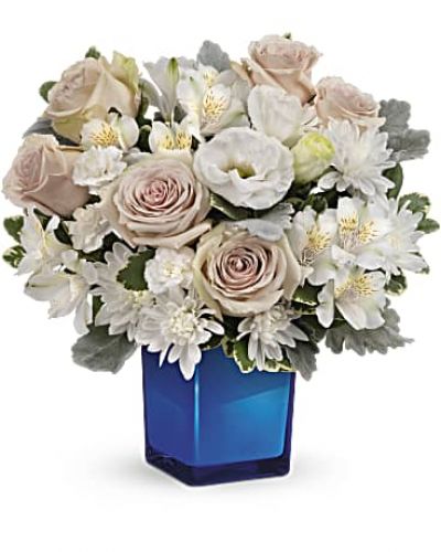 <div id="mark-3" class="m-pdp-tabs-marketing-description">Bursting with gorgeous roses and blooms, this cobalt glass cube vase is a gorgeous gift that can also serve as a beautiful candleholder!</div>
&nbsp;
<div id="desc-3">This splendid bouquet features crème roses, white cushion spray chrysanthemums, white lisianthus, white alstroemeria, miniature white carnations, dusty miller and variegated pittosporum.</div>