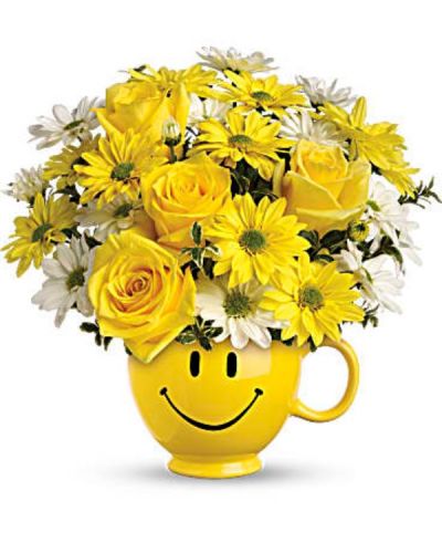 When you're looking to make someone smile, this happy face mug of roses and daisies is tops. Sure to cheer up everyone from a beloved wife to a busy boss, these are also great flowers for kids.
Yellow roses and daisy spray chrysanthemums along with white daisy spray chrysanthemums and oregonia are delivered in a happy yellow happy face mug.