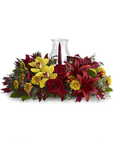 <div id="mark-3" class="m-pdp-tabs-marketing-description">Give thanks by sending this fall flower centerpiece. A chic, exotic spin on the traditional Thanksgiving centerpiece, it features orchids, roses, lilies and leucadendron in rich fall colors below a glowing taper candle, surrounded by a glass hurricane.</div>
&nbsp;
<div id="desc-3">
<ul>
 	<li>Yellow cymbidium orchids, red roses, burgundy asiatic lilies, bronze cushion mums, red leucadendron, seeded eucalyptus and salal are accented with red oak leaves.</li>
 	<li>A pomegranate taper candle inside a classic glass hurricane adds a warm glow to the room.</li>
</ul>
</div>