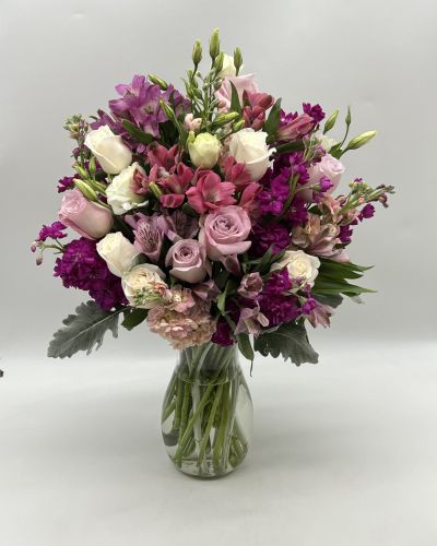 This beautiful bouquet features some gorgeous blooms that will brighten anyone's day with wonderful shades of purple!