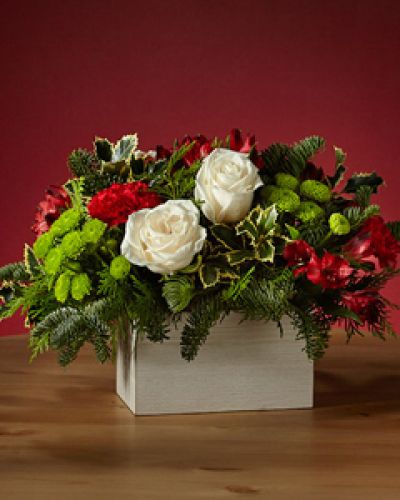 Dress the tablescape in winter wanderlust with our Snow Ball Bouquet and add an air of sophistication with the elegance of white roses. The holly lays over a white wooden box, perfect for a tasteful holiday gathering.
